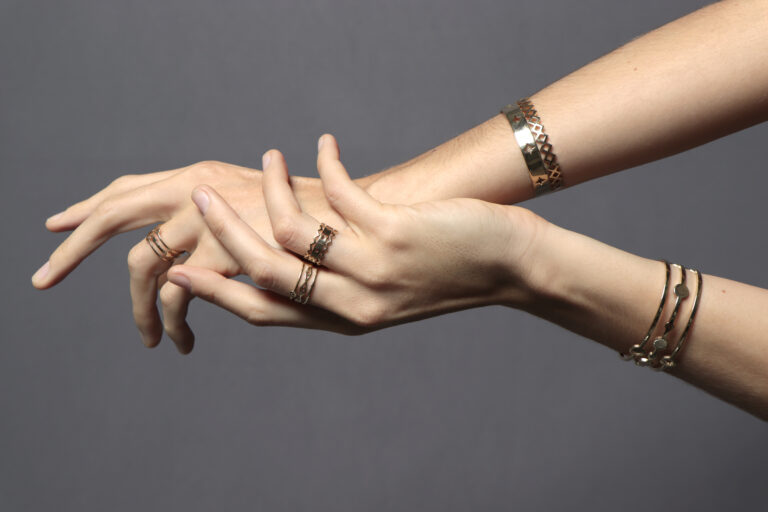 Mains avec des bijoux en argent qui noircissent la peau
